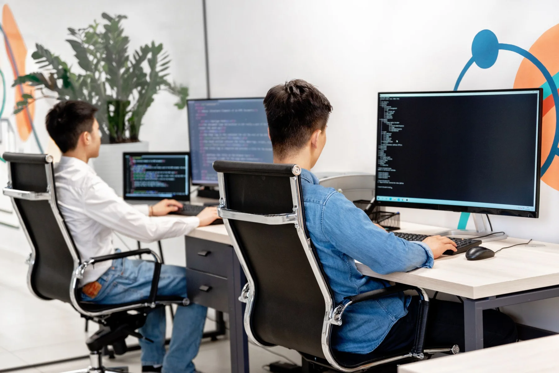 Engineers working together at computer workstations
