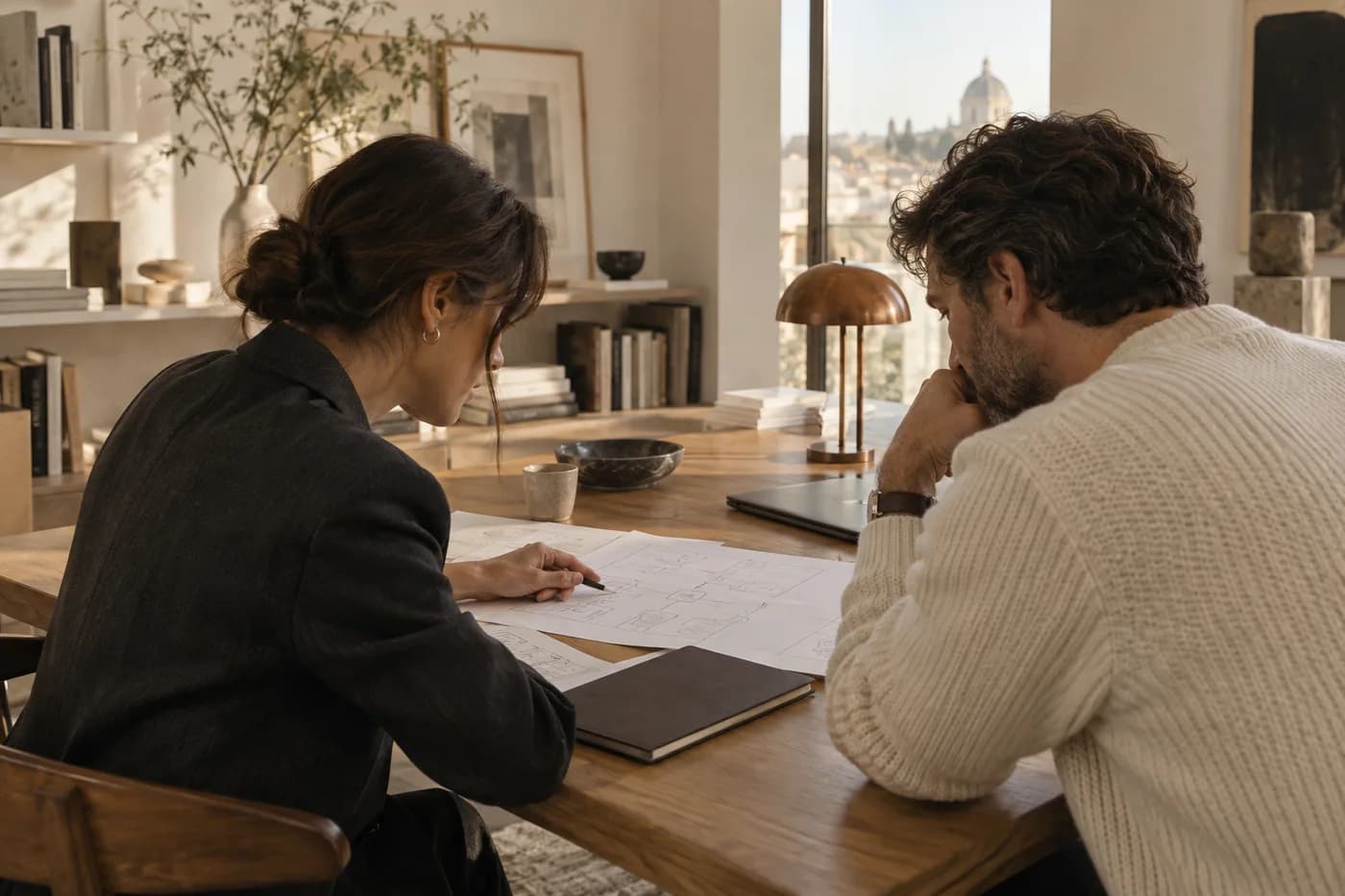 Illustrative scene of two people mapping a workflow together at a sunlit table